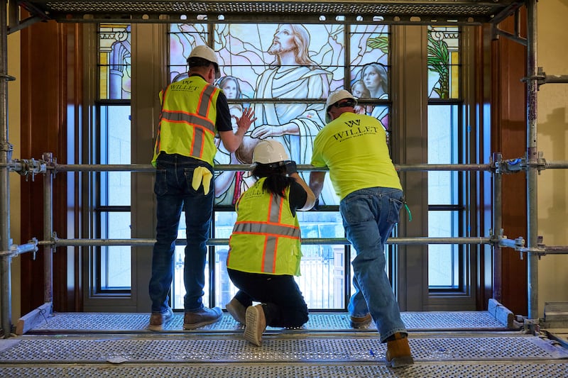 Los equipos colocan meticulosamente paneles de vidrio artístico en los edificios del acceso norte de la Manzana del Templo en Salt Lake City el miércoles, 11 de marzo de 2026.