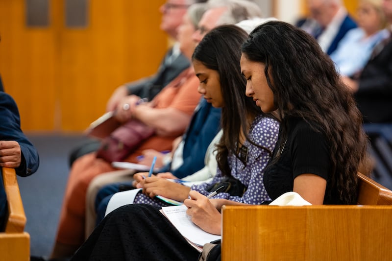 Sister missionaries serving in the Australia Brisbane Mission take notes during a devotional with visiting Apostle Elder Ronald A. Rasband, on March 16, 2024.