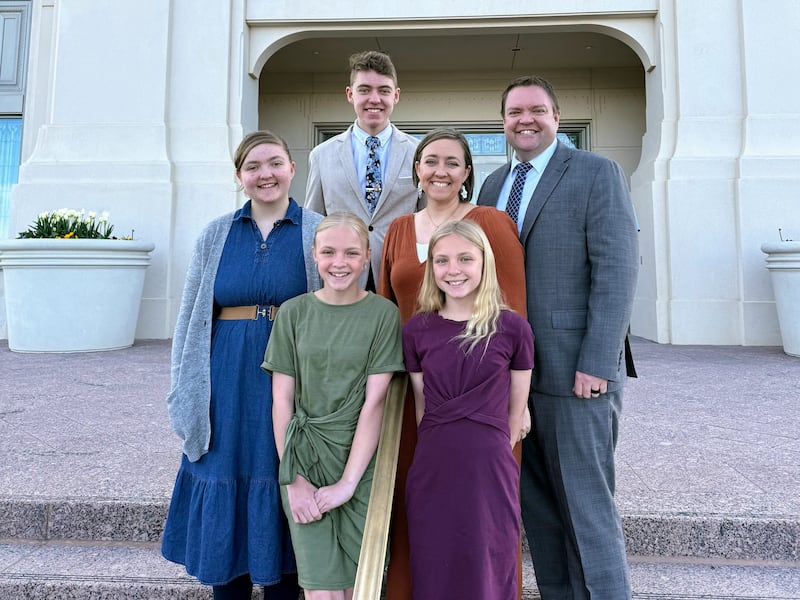 A family stands in front of the Layton Utah Temple.