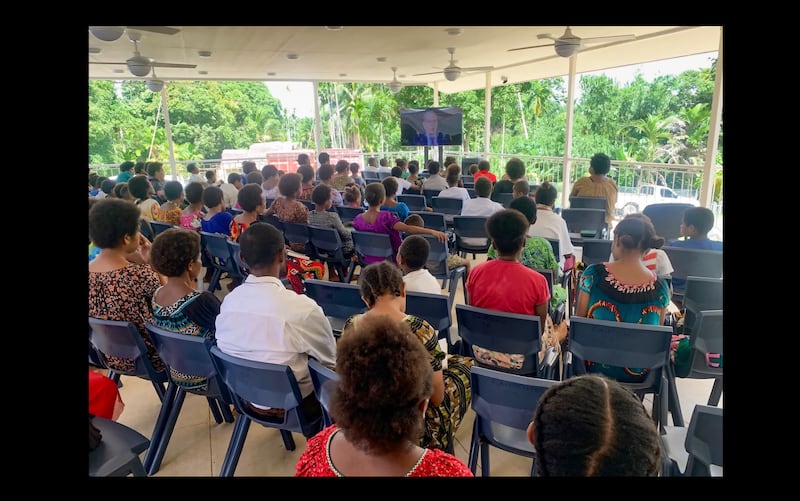 Los Santos de los Últimos Días en Papúa Nueva Guinea se reúnen para ver una transmisión en uno de los nuevos templos de reunión simplificados de la Iglesia, diseñados para llevar el programa de la Iglesia a las áreas más remotas del Pacífico.