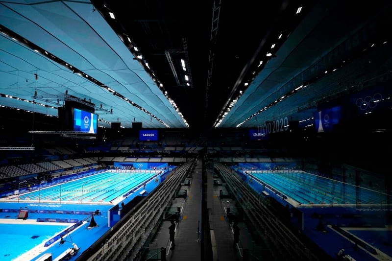 La piscina del Centro Acuático de Tokio se refleja en una ventana durante una sesión de entrenamiento de natación en los Juegos Olímpicos de Verano 2020, el miércoles, 21 de julio de 2021, en Tokio, Japón.