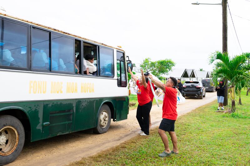 Los consejeros y líderes de FSY dan la bienvenida a los autobuses de jóvenes a una conferencia Para la Fortaleza de la Juventud en Tonga en diciembre de 2025.