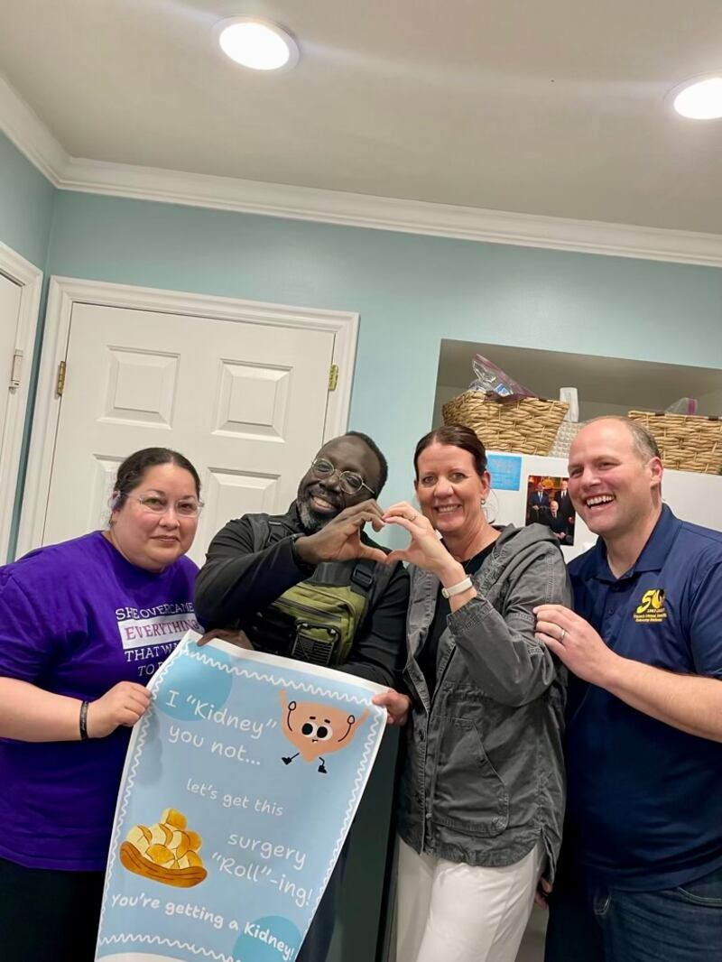 Shiller Joseph, second from left, and Krissy Miller, second from right, make a heart with their hands in March 2024 while celebrating the news that Miller could donate her kidney to Joseph.