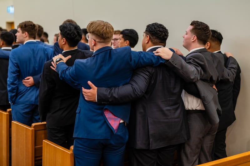 Elders serving in the Australia Brisbane Mission lock arms as they sing during a meeting with Elder Ronald A. Rasband of the Quorum of The Twelve Apostles on March 16, 2024.