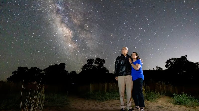 El élder Gerrit W. Gong y su esposa, la hermana Susan Gong, observan la Vía Láctea tarde en la noche en el desierto del sur de Utah.