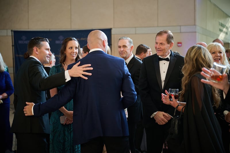 El élder Gary E. Stevenson, del Cuórum de los Doce Apóstoles, a la derecha, saluda a los invitados en la Gala Anual de la Medalla Canterbury de Becket en el Centro Nacional de la Constitución en Filadelfia el jueves 11 de junio de 2026. También están presentes el élder Alexander Dushku, Autoridad General Setenta, en el centro, y Derrick Porter, a la izquierda, productor, escritor principal y presentador de The Tabernacle at Temple Square.