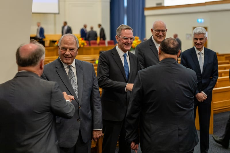 Elder Ronald A. Rasband of the Quorum of the Twelve Apostles, Pacific Area president Elder Peter F. Meurs, Elder Paul V. Johnson of the Presidency of the Seventy and Presiding Bishop Gérald Caussé shake hands with Latter-day Saints during a devotional in Brisbane, Australia, on March 16, 2024.