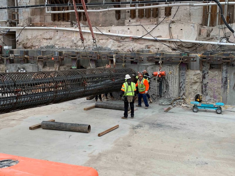 Durante el proceso de fortalecimiento sísmico llamado perforación con gato y taladro, los tubos se refuerzan con acero y se rellenan con concreto estructural para que actúen como vigas de soporte debajo de los cimientos existentes del Templo de Salt Lake como parte del proyecto de renovación de la Manzana del Templo en el centro de Salt Lake City durante diciembre de 2021.