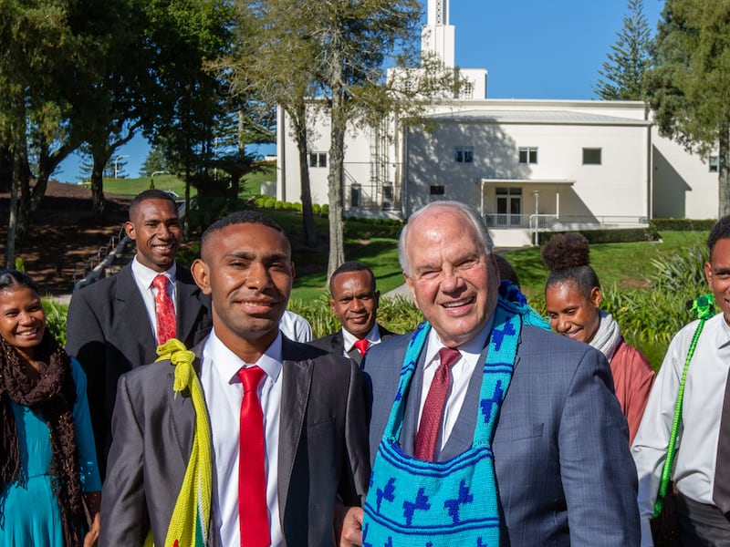 Elder Ronald A. Rasband of the Quorum of the Twelve Apostles wears a bag called a bilum given to him by 11 prospective missionaries from Papua New Guinea.