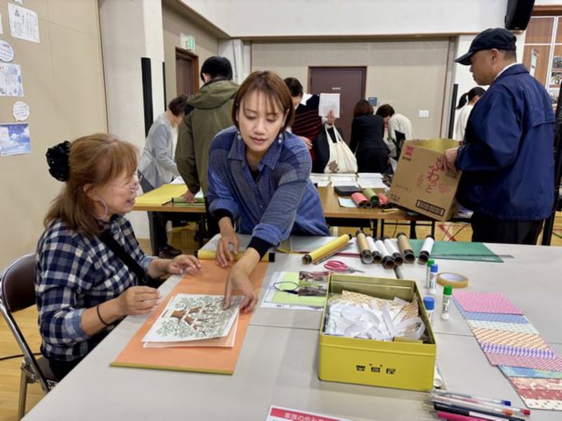 Los participantes crean rollos de historia familiar en una feria de historia familiar en Kioto, Japón, el 25 de octubre de 2025.