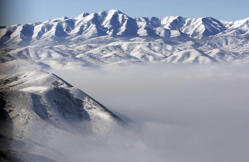 The tops of the Oquirrh and Wasatch mountains rise above a sea of haze in the Salt Lake Valley on Friday, Jan. 7, 2011.