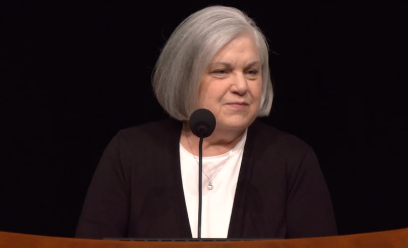 Sister Alynda Kusch speaking at a pulpit in the Conference Center Theater.