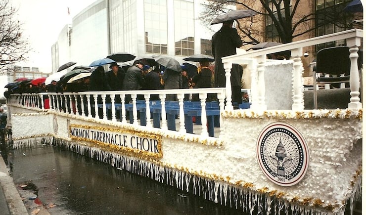 The Tabernacle Choir at Temple Square members carry umbrellas on a float for a parade that was part of the 2001 inauguration for President George W. Bush.
