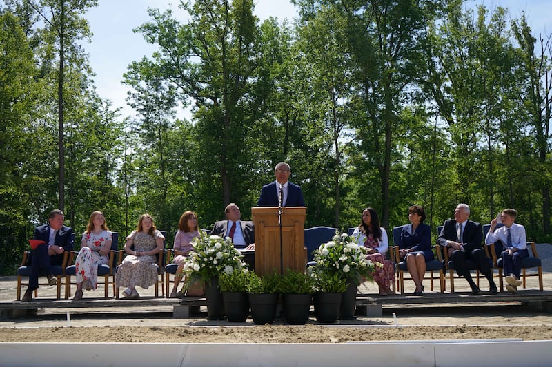 A speaker speaks at a groundbreaking ceremony.