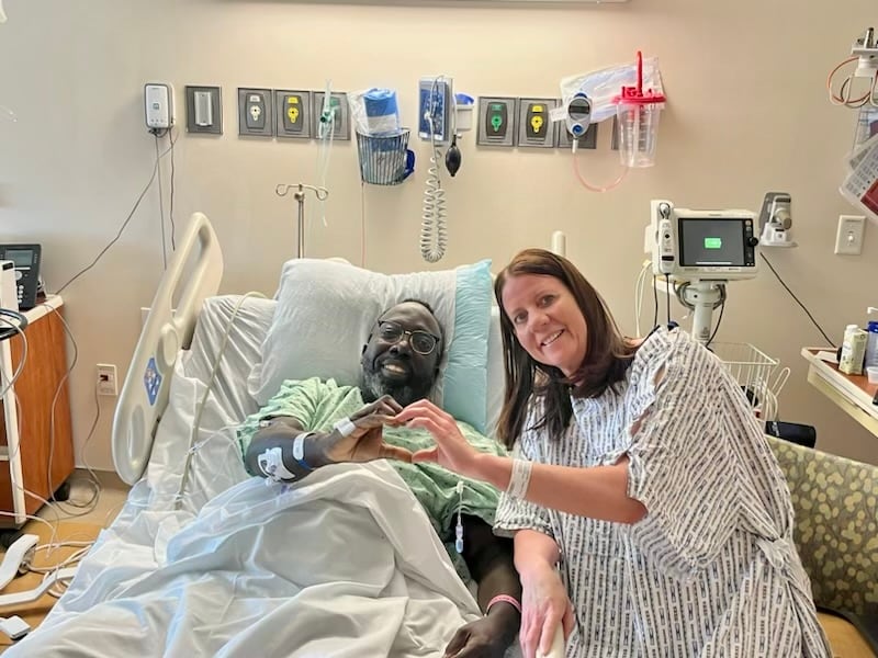 Shiller Joseph, left, and Krissy Miller make a heart with their hands while in the hospital. Miller met Joseph while hiking the Y in Provo, Utah, and donated her kidney to him in April 2024.