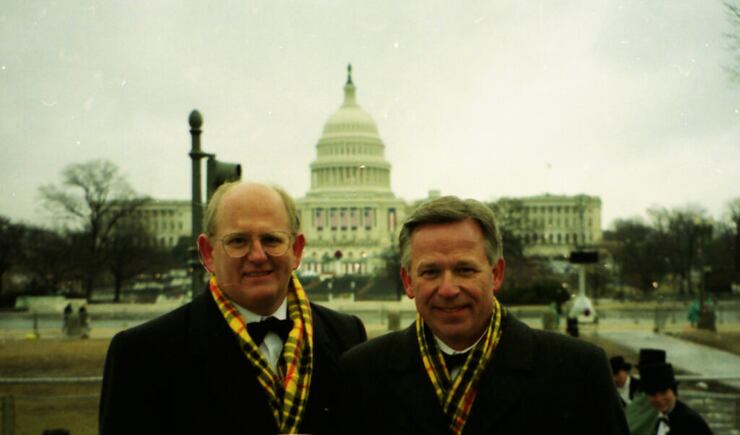 Mack Wilberg and Craig Jessop stand on the float with the U.S. Capitol Building dome in the background.