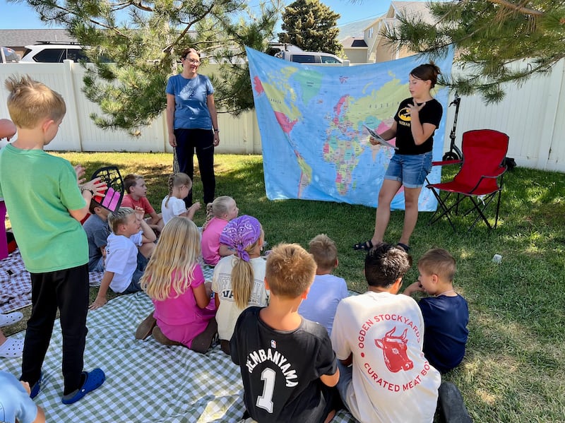 Madelynn Huffman, 12, una consultora juvenil de historia familiar en el Barrio Cherry Lane, Estaca Layton Utah Este, les cuenta a los niños de la Primaria sobre uno de sus antepasados durante un campamento de verano de historia familiar el lunes 28 de julio de 2025.