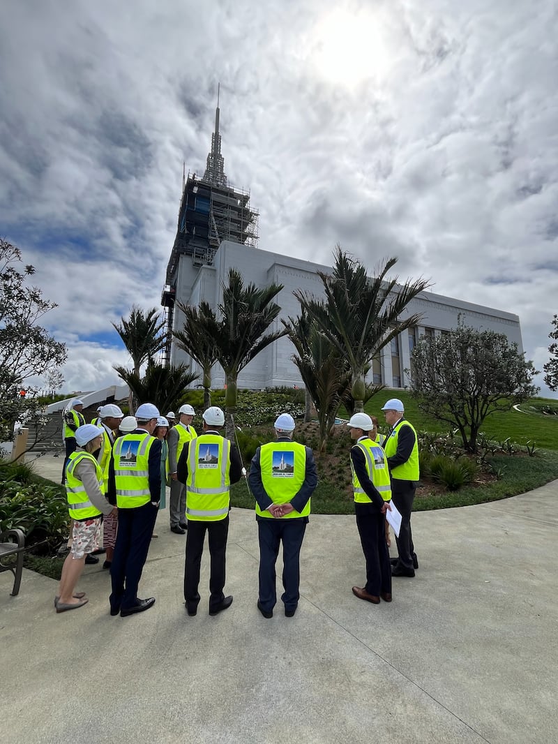 Elder Ronald A. Rasband of the Quorum of the Twelve Apostles meets with first-time temple patrons in front of the Hamilton New Zealand Temple on Monday, March 18, 2024.
