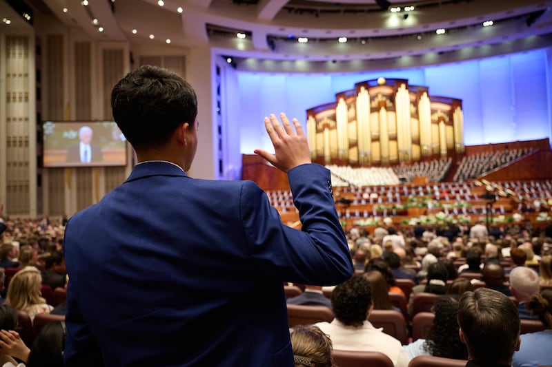 A young man gives a sustaining vote during the solemn assembly held during the Saturday morning session of the 196th Annual General Conference of The Church of Jesus Christ of Latter-day Saints in the Conference Center in Salt Lake City on April 4, 2026.