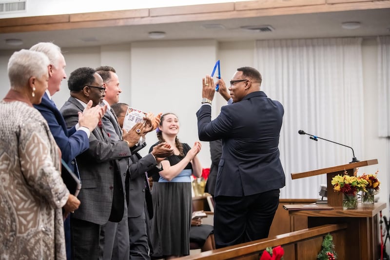 Sacher Dawson, director ejecutivo de Hope Farm, recibe su premio de servicio por la labor que Hope Farm realiza con los niños sin padre y sus madres solteras en la comunidad durante el devocional Santos en unidad en Fort Worth, Texas, el 16 de noviembre de 2025.