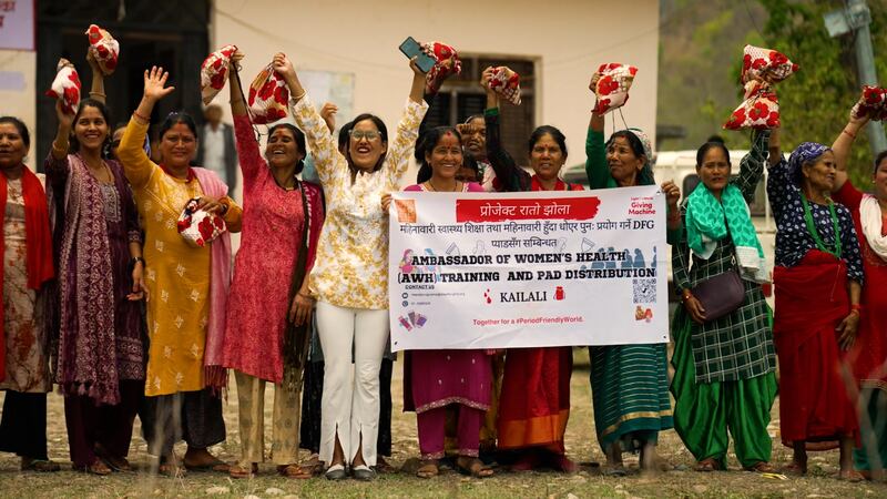 Mujeres y niñas muestran su gratitud al sostener los kits de salud menstrual que recibieron a inicios de mayo de 2025. Los kits, que incluyen toallas reutilizables de Days for Girls Nepal, fueron posibles gracias a las donaciones realizadas mediante la iniciativa de las Máquinas de Donación Ilumina el Mundo patrocinada por La Iglesia de Jesucristo de los Santos de los Últimos Días.